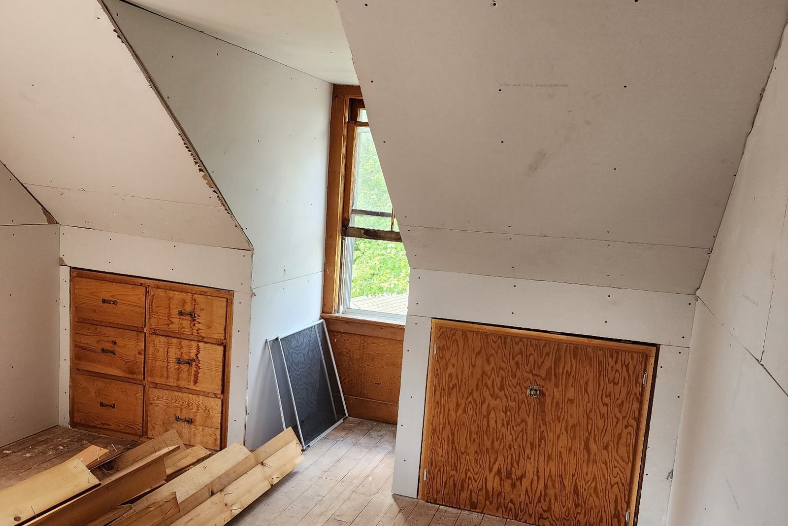 A room taken back to bare boards and studs partway through a remodel